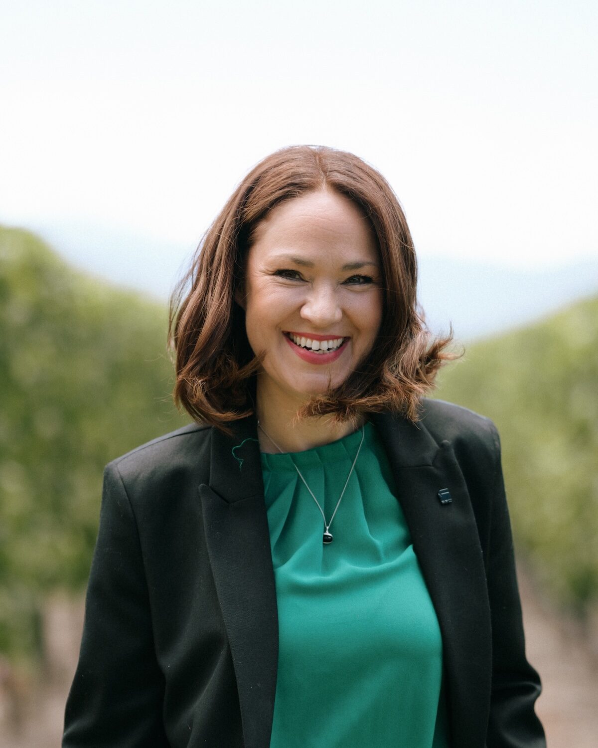 Kat Jankowiec, winemaker and founder of The Katalyst, smiling in a Marlborough vineyard
